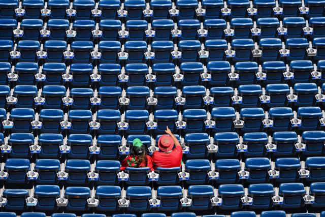 Two Morocco fans sit in the otherwise empty stands ahead of the 2026 World Cup football tournament quarter-final match between France and Morocco at Boston Stadium in Foxborough on July 9, 2026.  (Photo by ANGELA WEISS / AFP)