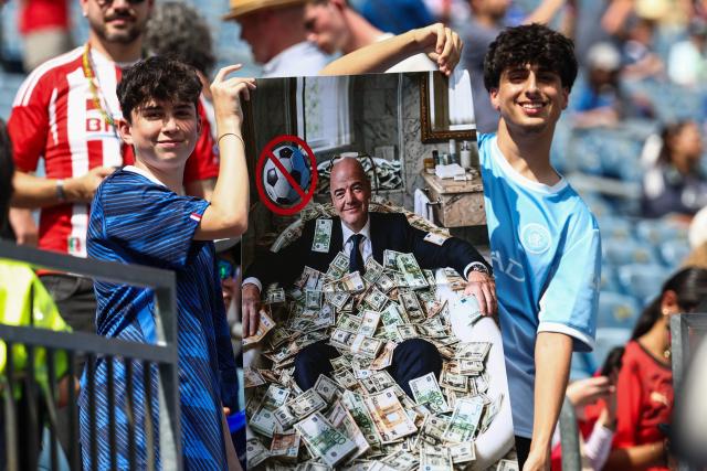 Football fans show a sign depicting FIFA President Gianni Infantino ahead of the 2026 World Cup football tournament quarter-final match between France and Morocco at Boston Stadium in Foxborough on July 9, 2026.  (Photo by FRANCK FIFE / AFP)