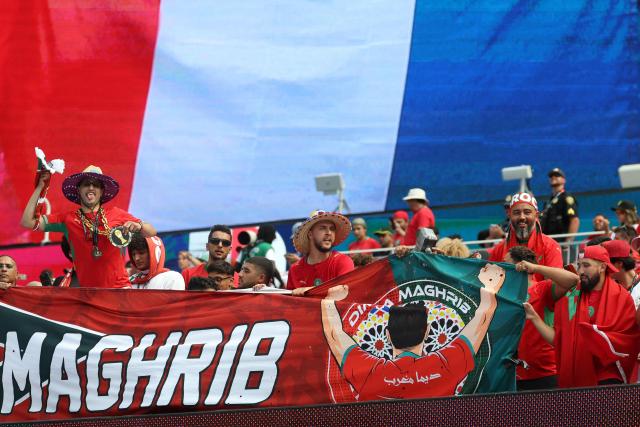 Moroccan fans cheer for their team with a French flag in the background ahead of the 2026 World Cup football tournament quarter-final match between France and Morocco at Boston Stadium in Foxborough on July 9, 2026.  (Photo by Odd ANDERSEN / AFP)