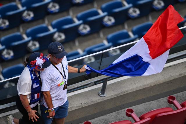 France fans hold a flag ahead of the 2026 World Cup football tournament quarter-final match between France and Morocco at Boston Stadium in Foxborough on July 9, 2026.  (Photo by ANGELA WEISS / AFP)