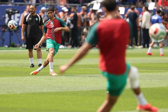 Morocco's defender #02 Achraf Hakimi warms up ahead of the 2026 World Cup football tournament quarter-final match between France and Morocco at Boston Stadium in Foxborough on July 9, 2026.  (Photo by Odd ANDERSEN / AFP)
