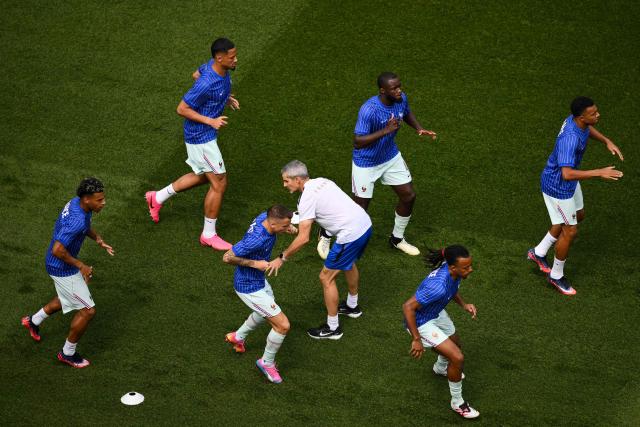 France's forward #10 Kylian Mbappe (top R), France's defender #04 Dayot Upamecano (top C) and teammates warm up ahead of the 2026 World Cup football tournament quarter-final match between France and Morocco at Boston Stadium in Foxborough on July 9, 2026.  (Photo by ANGELA WEISS / AFP)