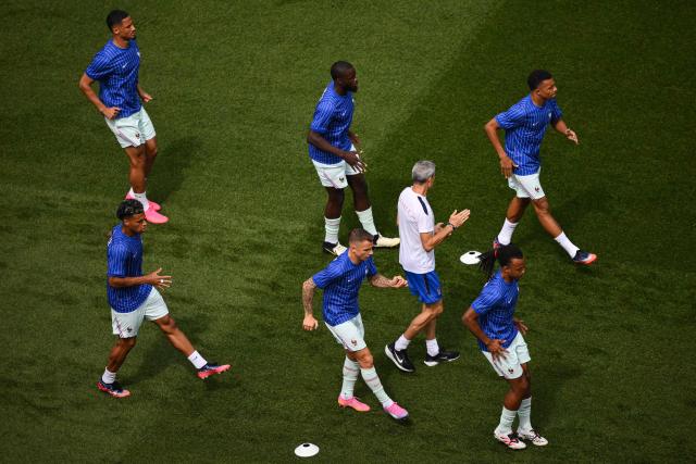 France's forward #10 Kylian Mbappe (top R), France's defender #04 Dayot Upamecano (top C) and teammates warm up ahead of the 2026 World Cup football tournament quarter-final match between France and Morocco at Boston Stadium in Foxborough on July 9, 2026.  (Photo by ANGELA WEISS / AFP)