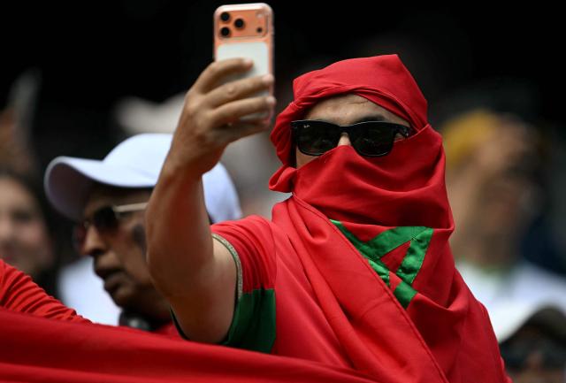 A Moroccan fan takes pictures ahead of the 2026 World Cup football tournament quarter-final match between France and Morocco at Boston Stadium in Foxborough on July 9, 2026.  (Photo by MAURO PIMENTEL / AFP)