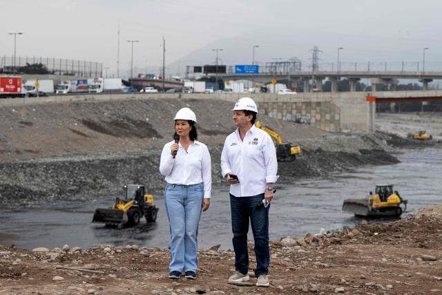 Peru's president-elect for the Fuerza Popular party, Keiko Fujimori (L), speaks next to the mayor of Lima Sergio Reggiardo (R) during a cleaning and desilting operation on the Rimac river as a preventive measure against the El Niño phenomenon, in Lima on July 9, 2026. (Photo by Ernesto BENAVIDES / AFP)
