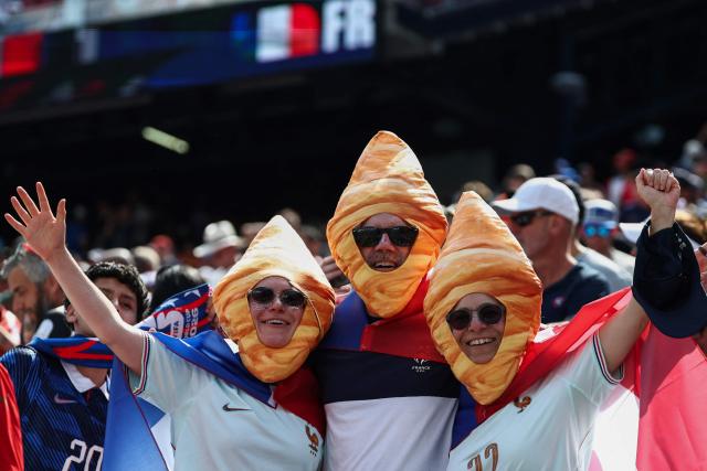 French fans wearing croissant costumes pose for a photo ahead of the 2026 World Cup football tournament quarter-final match between France and Morocco at Boston Stadium in Foxborough on July 9, 2026.  (Photo by FRANCK FIFE / AFP)