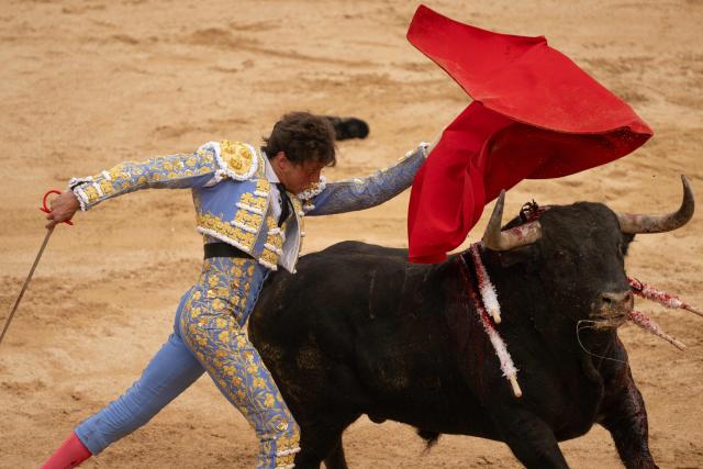EDITORS NOTE: Graphic content / Peruvian bullfighter Roca Rey performs a pass to a bull with "muleta" during a bullfight at the San Fermin festival in Pamplona, northern Spain, on July 9, 2026. (Photo by JORGE GUERRERO / AFP)
