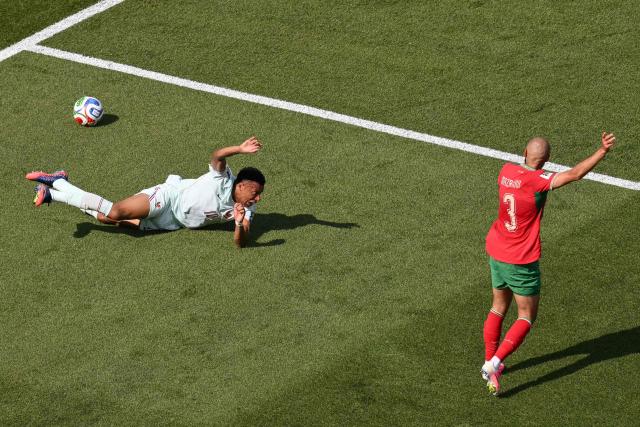France's forward #10 Kylian Mbappe falls after being fouled by Morocco's defender #03 Noussair Mazraoui during the 2026 World Cup football tournament quarter-final match between France and Morocco at Boston Stadium in Foxborough on July 9, 2026.  (Photo by ANGELA WEISS / AFP)