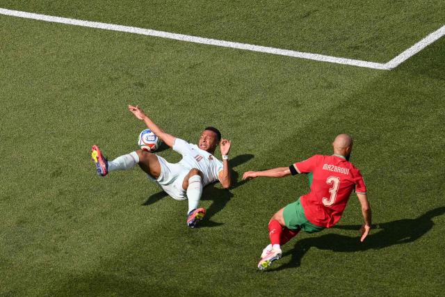 France's forward #10 Kylian Mbappe falls after being fouled by Morocco's defender #03 Noussair Mazraoui during the 2026 World Cup football tournament quarter-final match between France and Morocco at Boston Stadium in Foxborough on July 9, 2026.  (Photo by ANGELA WEISS / AFP)
