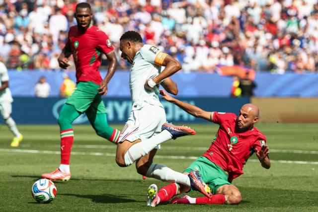 France's forward #10 Kylian Mbappe is fouled by Morocco's defender #03 Noussair Mazraoui during the 2026 World Cup football tournament quarter-final match between France and Morocco at Boston Stadium in Foxborough on July 9, 2026.  (Photo by FRANCK FIFE / AFP)
