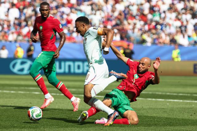 France's forward #10 Kylian Mbappe is fouled by Morocco's defender #03 Noussair Mazraoui during the 2026 World Cup football tournament quarter-final match between France and Morocco at Boston Stadium in Foxborough on July 9, 2026.  (Photo by FRANCK FIFE / AFP)