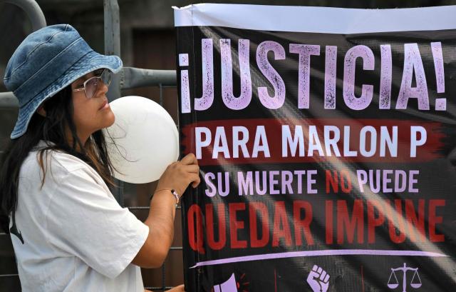 A woman holds a banner during a sit-in to demand the government to intensify the search of five security guards who disappeared in mid-June on the high seas, outside the Carondelet Palace, in Quito on July 9, 2026. (Photo by Rodrigo BUENDIA / AFP)