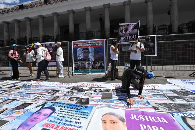 Family members and friends of five security guards who disappeared in mid-June on the high seas hold a sit-in to demand the government to intensify their search, outside the Carondelet Palace, in Quito on July 9, 2026. (Photo by Rodrigo BUENDIA / AFP)