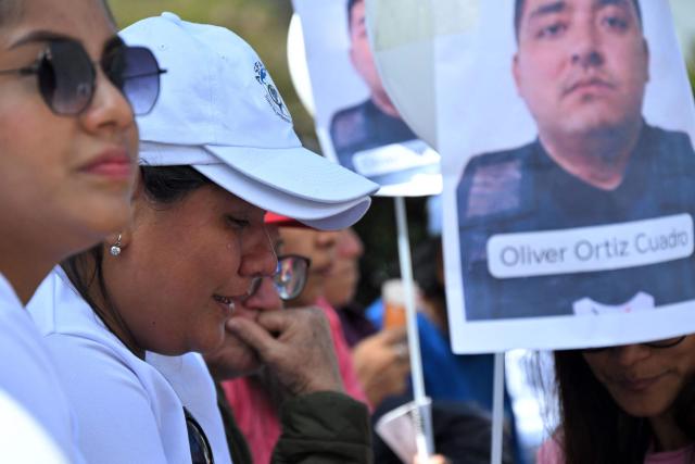 A woman weeps during a sit-in to demand the government to intensify the search of five security guards who disappeared in mid-June on the high seas, outside the Carondelet Palace, in Quito on July 9, 2026. (Photo by Rodrigo BUENDIA / AFP)