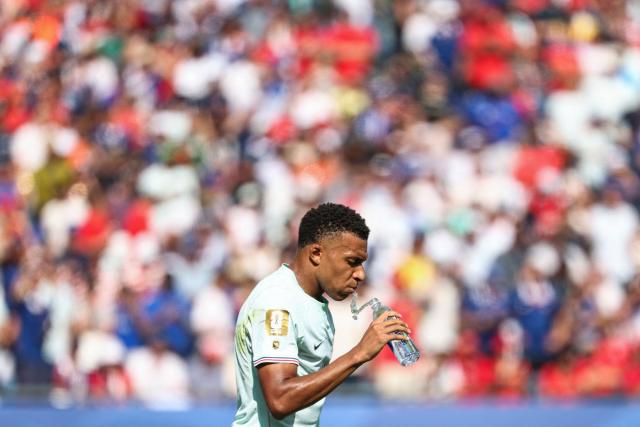 France's forward #10 Kylian Mbappe drinks water as he prepares to take a penalty kick during the 2026 World Cup football tournament quarter-final match between France and Morocco at Boston Stadium in Foxborough on July 9, 2026.  (Photo by FRANCK FIFE / AFP)