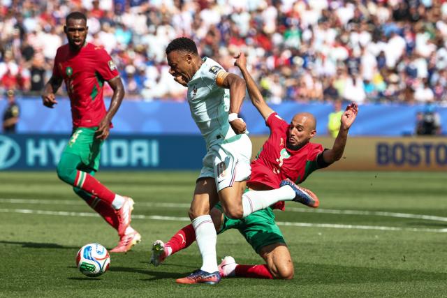 France's forward #10 Kylian Mbappe is fouled by Morocco's defender #03 Noussair Mazraoui to concede a penalty during the 2026 World Cup football tournament quarter-final match between France and Morocco at Boston Stadium in Foxborough on July 9, 2026.  (Photo by FRANCK FIFE / AFP)