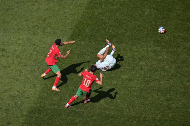 Morocco's defender #02 Achraf Hakimi and Morocco's forward #10 Brahim Diaz gesture as France's forward #10 Kylian Mbappe falls to the pitch during the 2026 World Cup football tournament quarter-final match between France and Morocco at Boston Stadium in Foxborough on July 9, 2026.  (Photo by ANGELA WEISS / AFP)