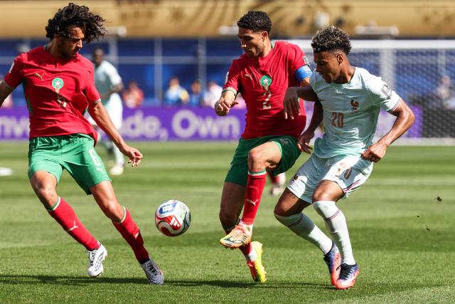 Morocco's midfielder #06 Ayyoub Bouaddi, defender #02 Achraf Hakimi, and France's forward #20 Desire Doue fight for the ball during the 2026 World Cup football tournament quarter-final match between France and Morocco at Boston Stadium in Foxborough on July 9, 2026.  (Photo by FRANCK FIFE / AFP)