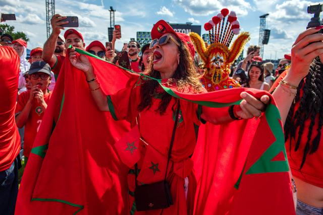 Moroccan fans cheer for their team during a watch party for the World Cup round of 8 match between France and Morocco in Boston, Massachusetts, on July 9, 2026. (Photo by Joseph Prezioso / AFP)