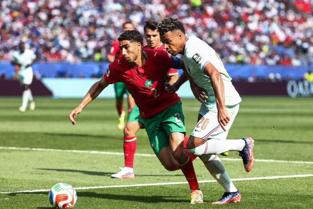 Morocco's defender #02 Achraf Hakimi and France's forward #20 Desire Doue fight for the ball during the 2026 World Cup football tournament quarter-final match between France and Morocco at Boston Stadium in Foxborough on July 9, 2026.  (Photo by FRANCK FIFE / AFP)
