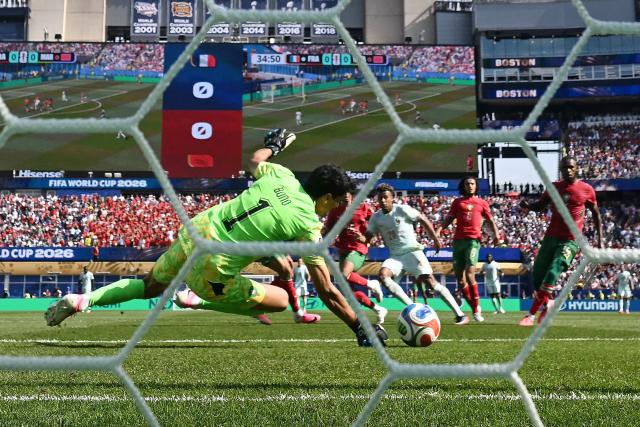 Morocco's goalkeeper #01 Yassine Bounou makes a save past France's forward #20 Desire Doue during the 2026 World Cup football tournament quarter-final match between France and Morocco at Boston Stadium in Foxborough on July 9, 2026.  (Photo by MAURO PIMENTEL / AFP)