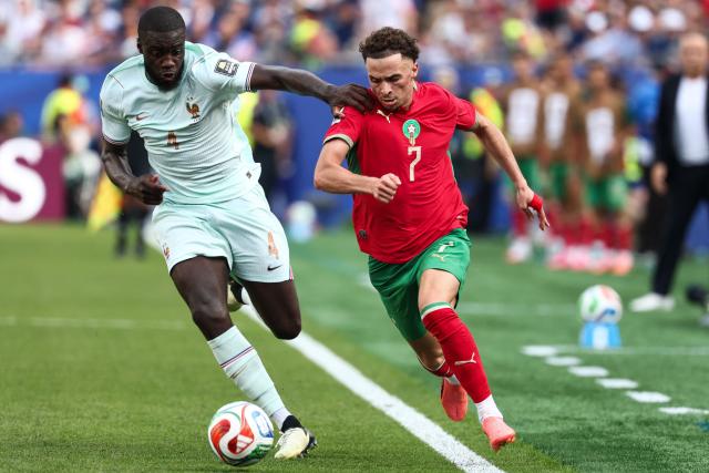 France's defender #04 Dayot Upamecano and Morocco's forward #07 Chemsdine Talbi fight for the ball during the 2026 World Cup football tournament quarter-final match between France and Morocco at Boston Stadium in Foxborough on July 9, 2026.  (Photo by FRANCK FIFE / AFP)