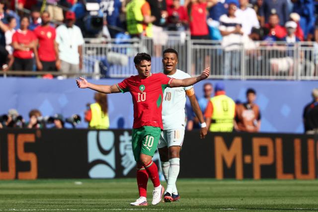 France's forward #10 Kylian Mbappe (R) celebrates scoring his team's first goal past Morocco's forward #10 Brahim Diaz during the 2026 World Cup football tournament quarter-final match between France and Morocco at Boston Stadium in Foxborough on July 9, 2026.  (Photo by FRANCK FIFE / AFP)