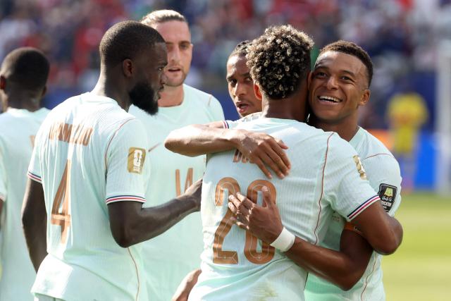 France's forward #10 Kylian Mbappe (R) celebrates scoring his team's first goal with teammate forward #20 Desire Doue during the 2026 World Cup football tournament quarter-final match between France and Morocco at Boston Stadium in Foxborough on July 9, 2026.  (Photo by Odd ANDERSEN / AFP)