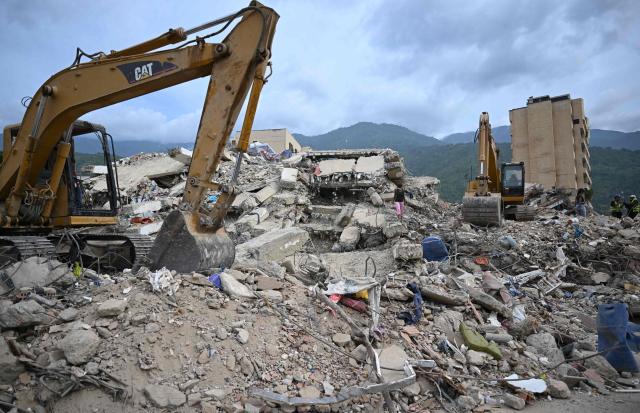 Retroexcavators remove debris from collapsed buildings in Caraballeda, La Guaira state, Venezuela, on July 9, 2026 following the June 24 earthquakes. The United Nations launched an urgent appeal on July 8, 2026 for nearly $300 million towards Venezuela earthquake relief operations as the death toll from the disaster rose to more than 3,800 people. (Photo by Raul ARBOLEDA / AFP)