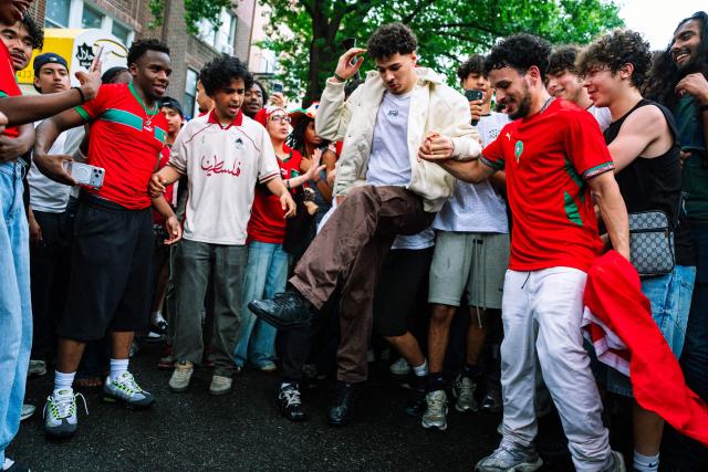Moroccan fans celebrate their team participation in the World Cup, despite the 2-0 loss against France in the quarter-final match between France and Morocco in the Little Morocco area in the Queens borough of New York City on July 9, 2026. (Photo by Angelina Katsanis / AFP)