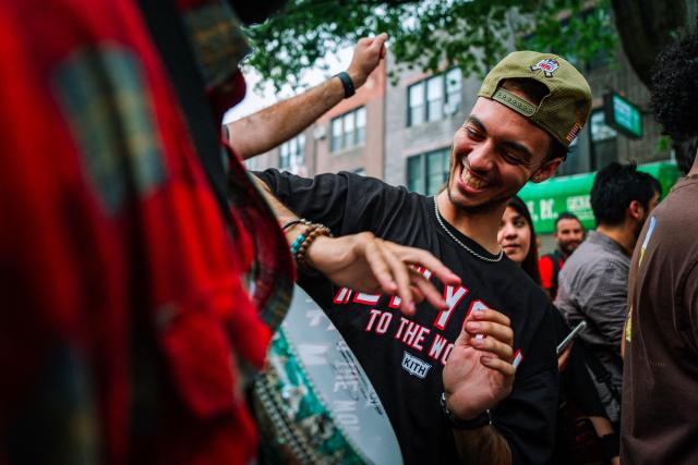 A Moroccan fan celebrates his team participation in the World Cup, despite the 2-0 loss against France in the quarter-final match between France and Morocco in the Little Morocco area in the Queens borough of New York City on July 9, 2026. (Photo by Angelina Katsanis / AFP)