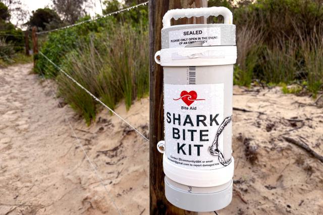 This picture taken on July 6, 2026 shows a recently installed shark bite kit attached to a fence on Narrawallee Beach in Mollymook, located south of Sydney. Four people have been killed in an unusual spate of shark attacks around Australia so far this year. There have been nearly 1,300 shark incidents around Australia since 1791, of which more than 260 resulted in death, according to a database of shark encounters with humans. (Photo by DAVID GRAY / AFP)