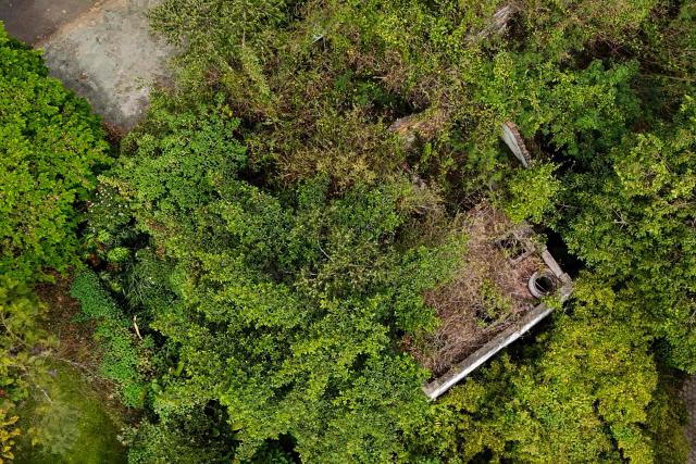 This aerial view shows the ruins of a property belonging to former Colombian National Team goalkeeper Rene Higuita in the El Poblado neighborhood of Medellin, Colombia, on July 9, 2026. A Colombian court on July 9 ordered the seizure of a property belonging to former footballer Rene Higuita after concluding that funds from Pablo Escobar's cartel were used to purchase the house. (Photo by Diego Botero / AFP)