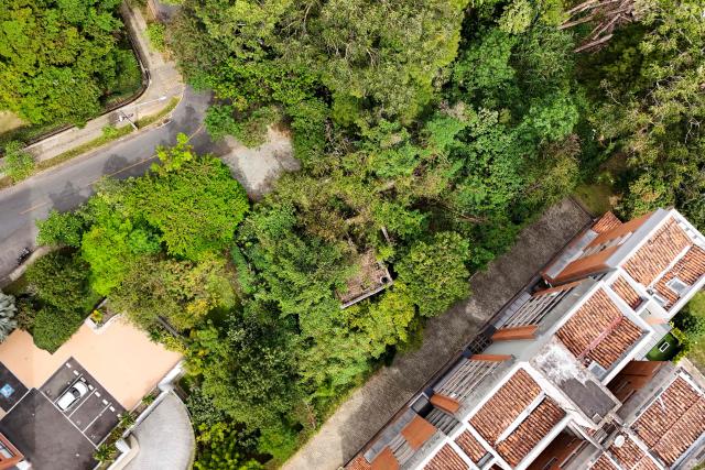 This aerial view shows the ruins of a property (C) belonging to former Colombian National Team goalkeeper Rene Higuita in the El Poblado neighborhood of Medellin, Colombia, on July 9, 2026. A Colombian court on July 9 ordered the seizure of a property belonging to former footballer Rene Higuita after concluding that funds from Pablo Escobar's cartel were used to purchase the house. (Photo by Diego Botero / AFP)
