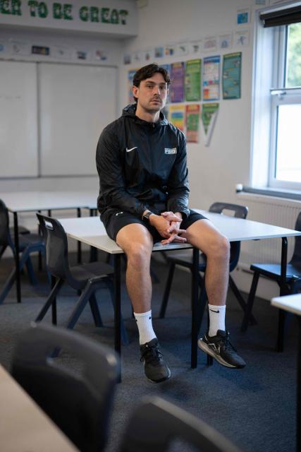 Matt Bishop a member of staff with 'Football Beyond Borders', poses for a photograph in Our Lady & St Chad Catholic School, Wolverhampton, central England on June 12, 2026. FBB (Football Beyond Borders) works with young people from areas of socio-economic disadvantage who are disengaged at school but passionate about football, to help them finish school with the skills and grades to make a successful transition into adulthood. (Photo by Oli SCARFF / AFP) / TO GO WITH AFP STORY BY Alexandra Del PERAL