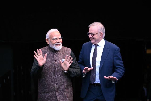 Indian Prime Minister Narendra Modi (L) reacts with Australia’s Prime Minister Anthony Albanese during a visit to the Melbourne Cricket Ground (MCG) on July 10, 2026. (Photo by WILLIAM WEST / AFP)
