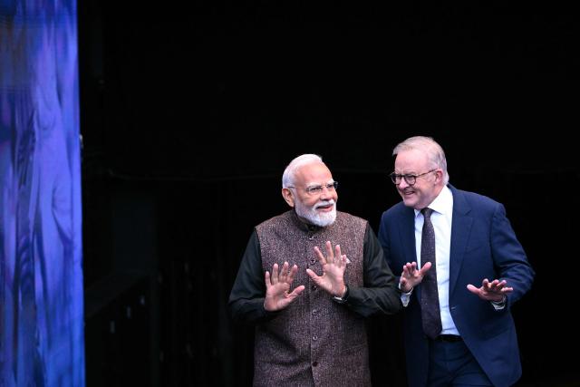 Indian Prime Minister Narendra Modi (L) reacts with Australia’s Prime Minister Anthony Albanese during a visit to the Melbourne Cricket Ground (MCG) on July 10, 2026. (Photo by WILLIAM WEST / AFP)