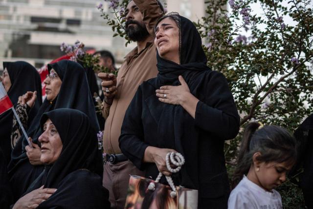 TOPSHOT - Mourners attend the funeral of Iran's slain supreme leader Ali Khamenei and members of his family, before he is buried at the Shrine of Imam Reza, in Mashhad on July 9, 2026. Calling for revenge and rejecting any compromise with the West, Iranians loyal to the Islamic republic braved sweltering heat on July 9 to mass for the burial of supreme leader Ali Khamenei in his hometown of Mashhad. (Photo by AFP) / 