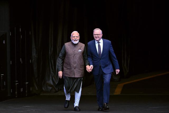 Indian Prime Minister Narendra Modi (L) walks with Australia’s Prime Minister Anthony Albanese during a visit to the Melbourne Cricket Ground (MCG) on July 10, 2026. (Photo by WILLIAM WEST / AFP)
