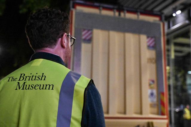 Nicholas Cullinan, director of the British Museum, waits for the truck (behind) carrying the Bayeux Tapestry to be unloaded at the museum in central London early on July 10, 2026, as the 11th-century artwork depicting the 1066 Norman conquest of England arrives ahead its first UK exhibition from September. The medieval Bayeux Tapestry arrived in London in the early hours of July 10, after a hugely complicated journey to leave France for the first time in more than 900 years for an exhibition in the British capital. (Photo by Richard A. Brooks / AFP)