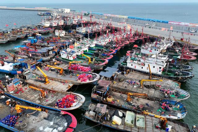 Fishing boats are moored as fishermen refrain from fishing in preparation for Typhoon Bavi, which is predicted to hit the region this weekend, in Lianyungang, China's eastern Jiangsu province on July 10, 2026. (Photo by CN-STR / AFP) / China OUT