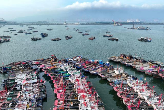 Fishing boats are moored as fishermen refrain from fishing in preparation for Typhoon Bavi, which is predicted to hit the region this weekend, in Lianyungang, China's eastern Jiangsu province on July 10, 2026. (Photo by CN-STR / AFP) / China OUT