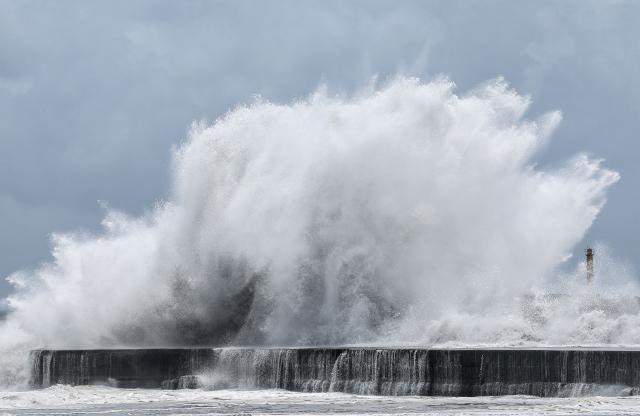 Strong waves break along the coast in Yilan on July 10, 2026, as Typhoon Bavi moves toward Northeastern Taiwan. (Photo by I-Hwa Cheng / AFP)