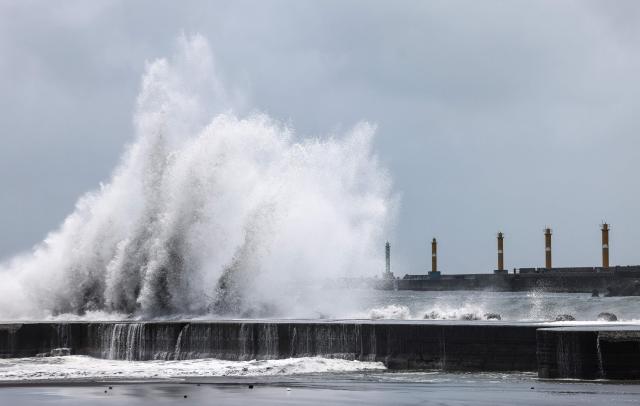 Strong waves break along the coast in Yilan on July 10, 2026, as Typhoon Bavi moves toward Northeastern Taiwan. (Photo by I-Hwa Cheng / AFP)