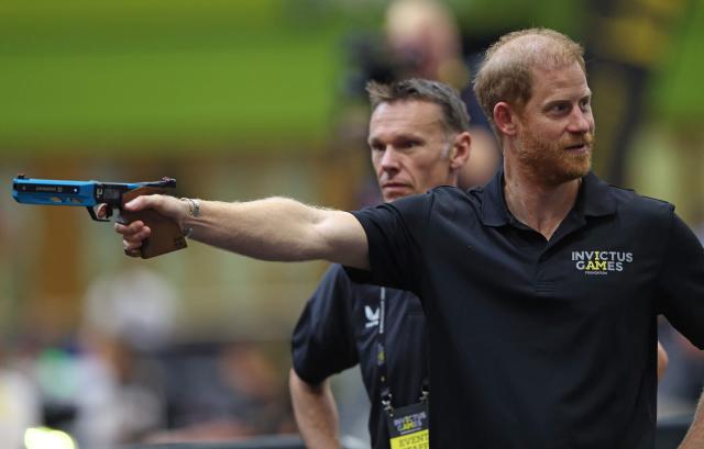 Britain's Prince Harry, Duke of Sussex, holds a Laser Pistol as he takes part in the shooting aspect of Laser Run, during an event to mark the 'Invictus Games Birmingham 2027: One Year To Go', at the NEC in Birmingham, central England on July 10, 2026. (Photo by Darren Staples / AFP)