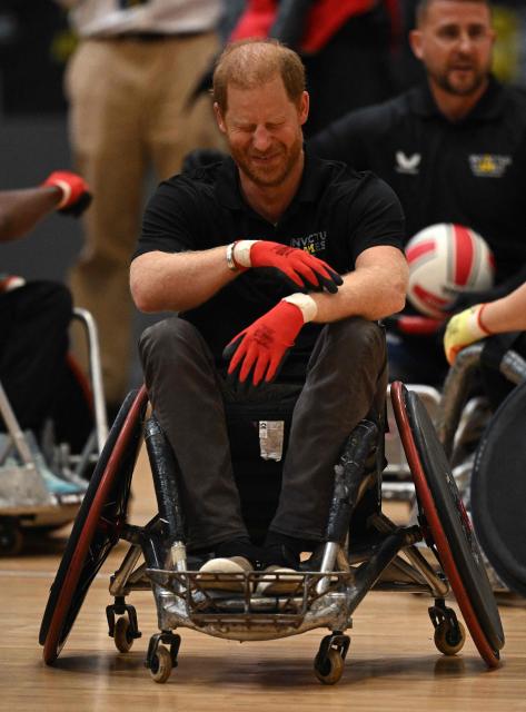 Britain's Prince Harry, Duke of Sussex, reacts as he takes part in a session of wheelchair rugby during an event to mark the 'Invictus Games Birmingham 2027: One Year To Go', at the NEC in Birmingham, central England on July 10, 2026. (Photo by Oli SCARFF / AFP)