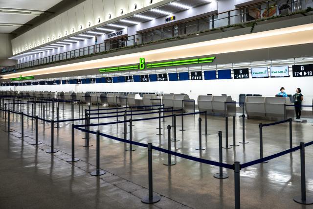 Staff members stand by at a check-in counter at Naha Airport in Naha, Okinawa prefecture, on July 10, 2026. Typhoon Bavi is expected to pound Taiwan's north and east, as well as Japan's remote southwestern islands, on July 10 and 11 before smashing into China, which has been hit by deadly storms this week. (Photo by Philip FONG / AFP)