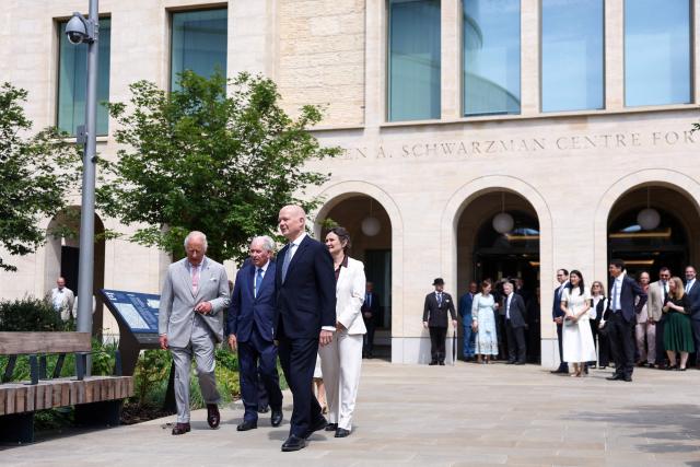 Britain's King Charles III walks with Oxford University Chancellor William Hague (3L) and Blackstone CEO Stephen A. Schwarzman (2L), as he visits the Stephen A. Schwarzman Centre for the Humanities at the University of Oxford, west of London on July 10, 2026. (Photo by Toby Shepheard / POOL / AFP)