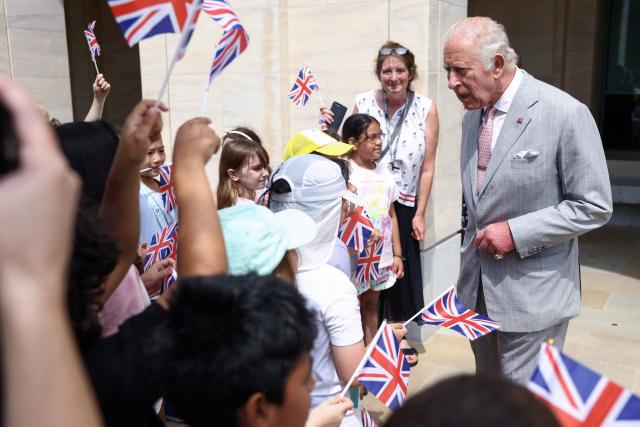 Britain's King Charles III chats with children waving Union flags as he visits the Stephen A. Schwarzman Centre for the Humanities at the University of Oxford, west of London on July 10, 2026. (Photo by Toby Shepheard / POOL / AFP)