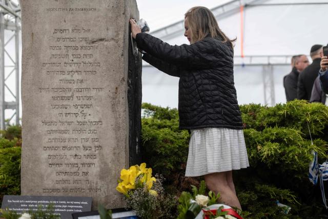 A participant prays as she pays tribute to the victims at the Jedwabne massacre monument during a ceremony honouring the memory of the town's Jewish residents murdered on July 10, 1941 by their Polish neighbours, in Jedwabne, north-eastern Poland, on July 10, 2026. Poland's Jewish community, political leaders and ordinary citizens on July 10 commemorated a massacre of hundreds of Jews killed by their Polish neighbors 85 years ago in the town of Jedwabne in then German-occupied Poland, at a ceremony opposed by far-right demonstrators. (Photo by Wojtek RADWANSKI / AFP)